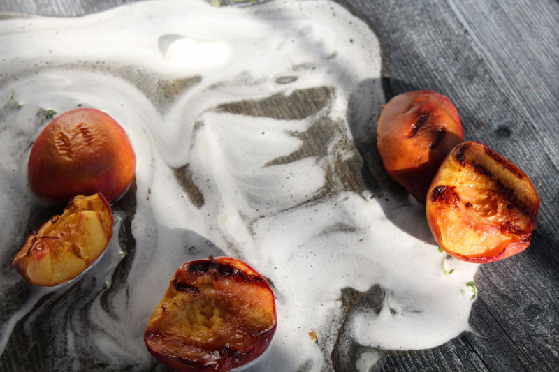 Grilled peaches covered in bourbon maple syrup
