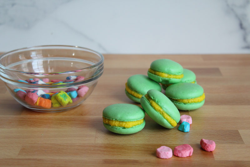 a bowl of marshmallows next to macaroons
