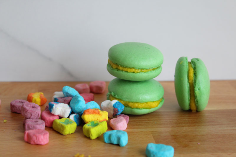 three macaroons next to a pile of marshmallows