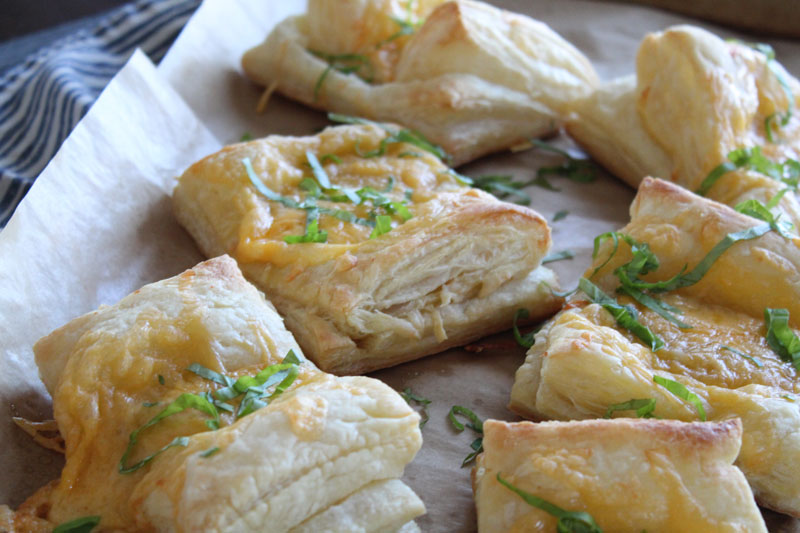 Baked cheese pastries sprinkled with basil